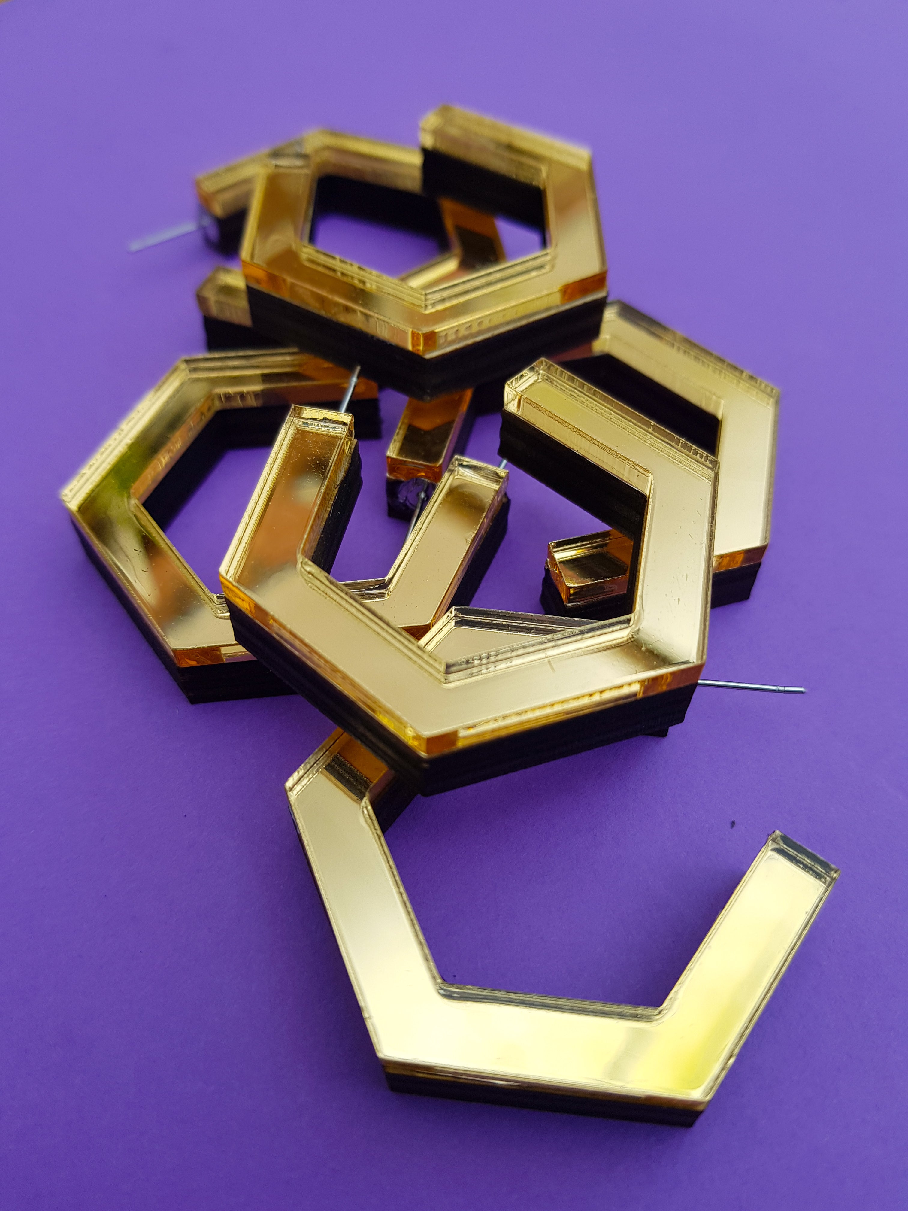 Gold hexagonal ply and perspex hoop earrings